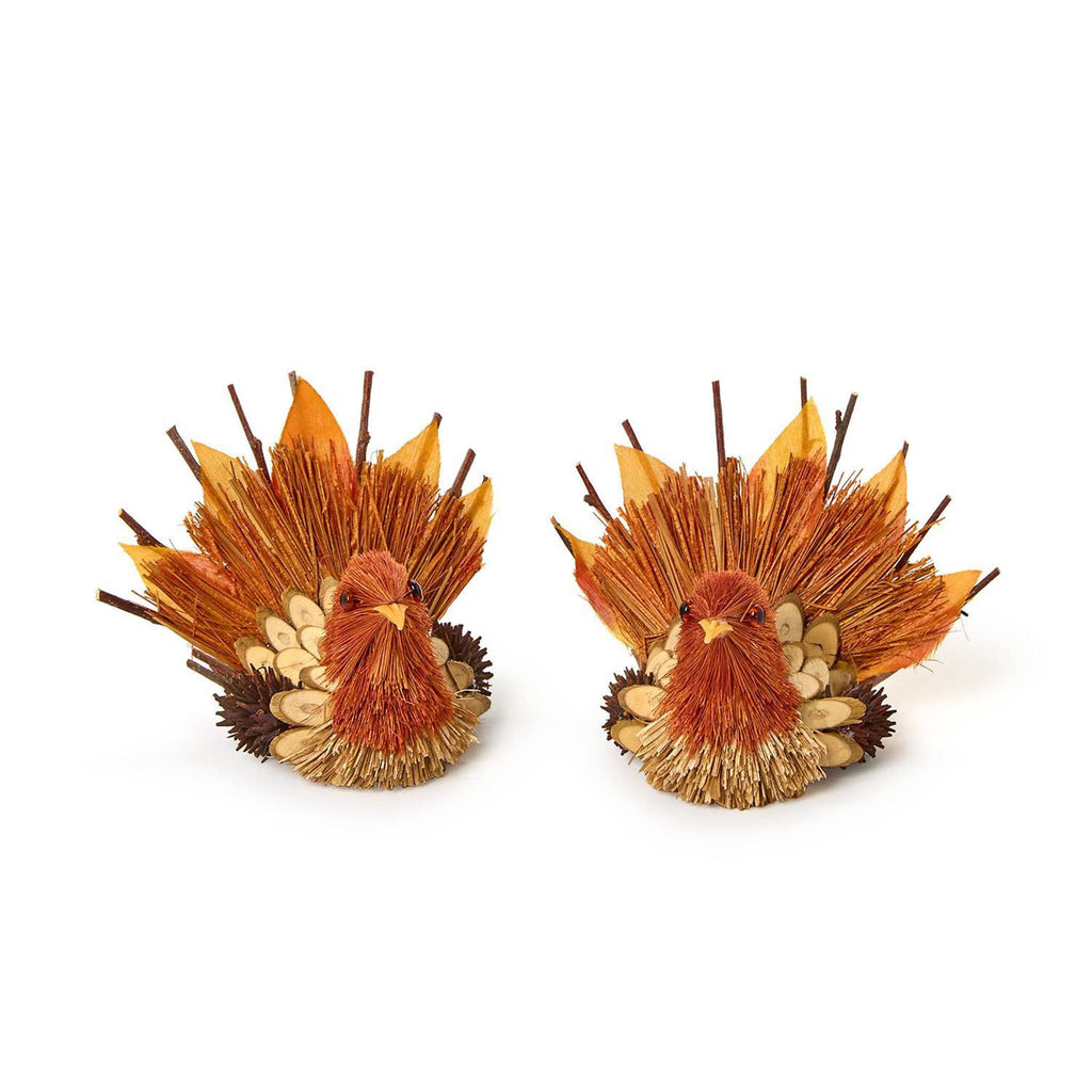 Two decorative turkey figurines made of natural materials on a white background.