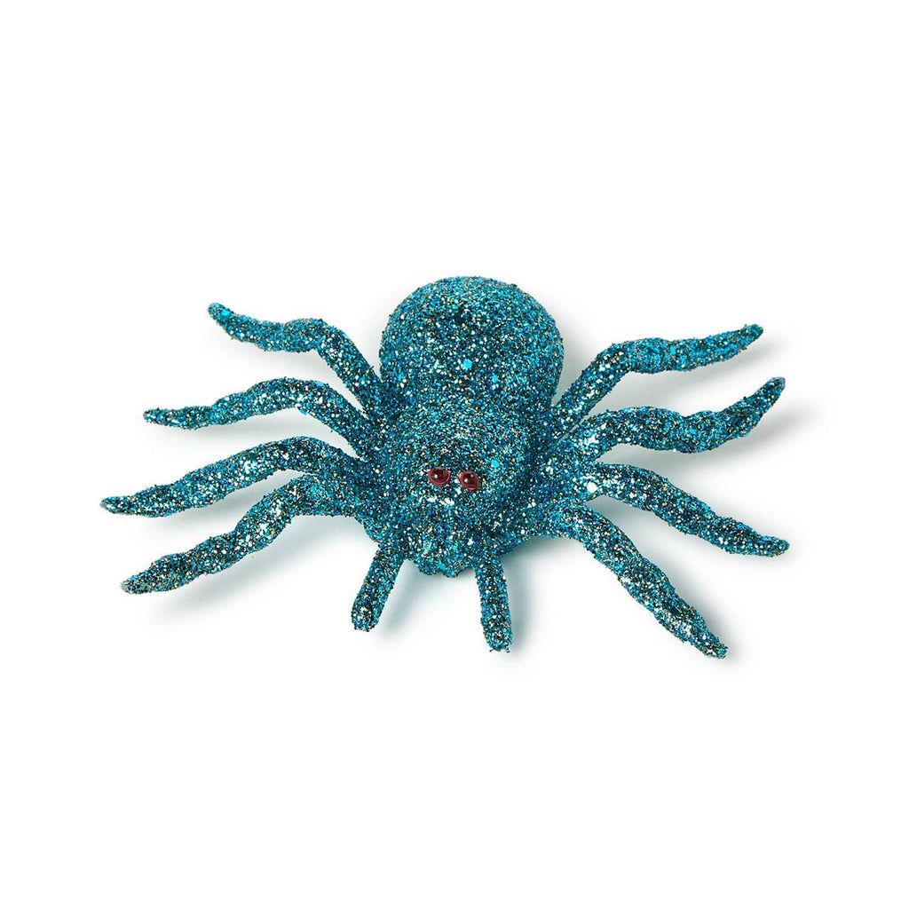 Turquoise blue glittery spider toy on a white background.