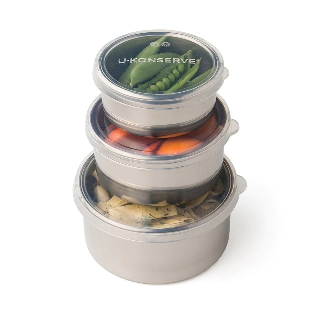 U-Konserve set of three round stainless steel food containers in 5 ounce, 9 ounce and 16 ounce capacity, each with a plastic-free, leakproof, clear silicone lid, containers are stacked with smallest on top.