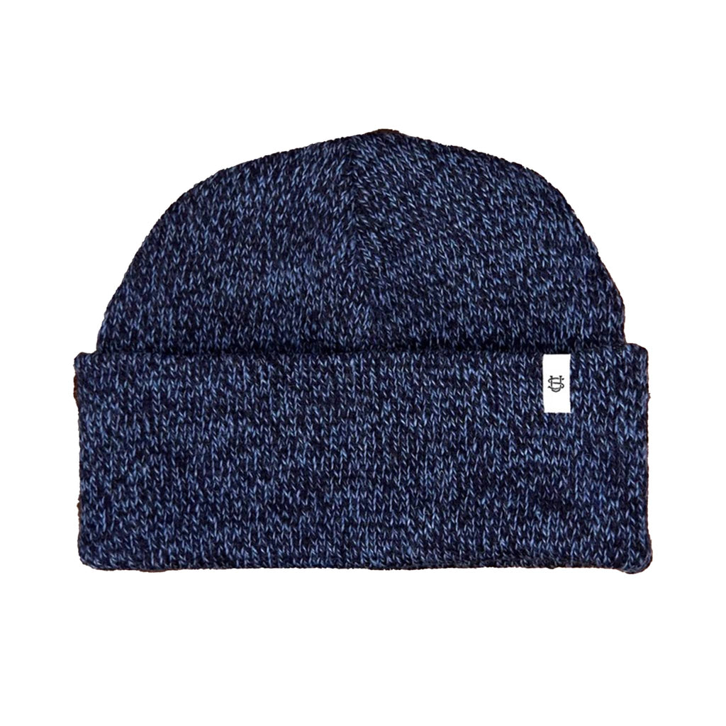 Blue and black wool knit beanie with a small white logo label on a white background.