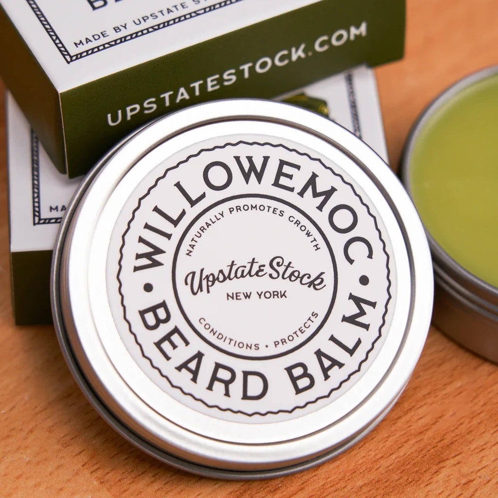 Willowemoc beard balm container with branding on a wooden surface.