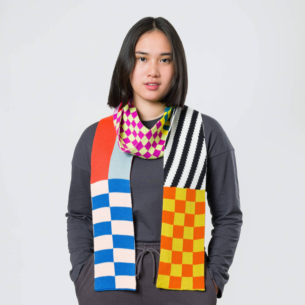 Verloop Pattern Patch Skinny Knit Scarf in rainbow colors on model.