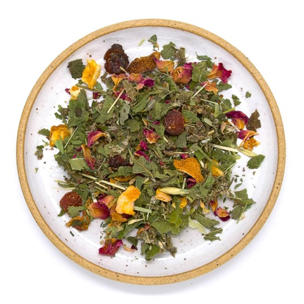 Wild & Tea Daily Nourish loose-leaf herbal tea spill on plate.