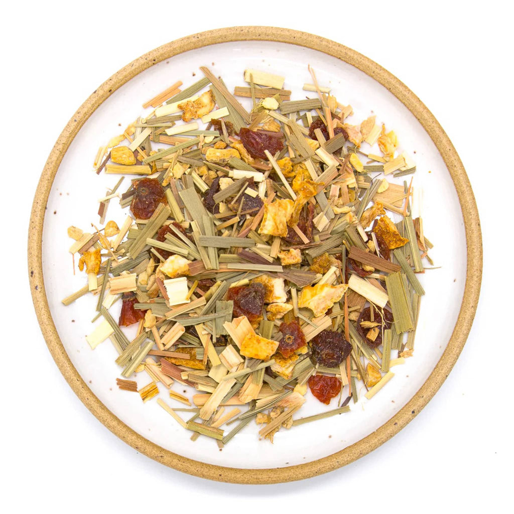 Wild & Tea Ginger Lemongrass loose-leaf herbal tea spill on plate.