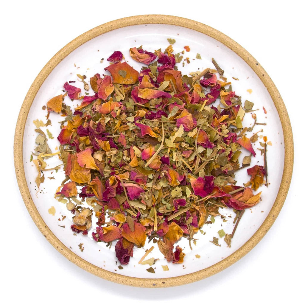 Wild & Tea Open Heart loose-leaf herbal tea spill on plate.