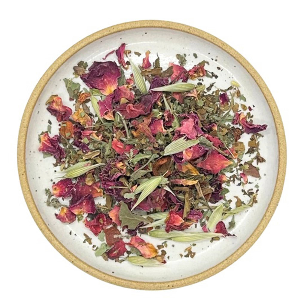 Wild & Tea Tulsi Time loose-leaf herbal tea spill on plate.