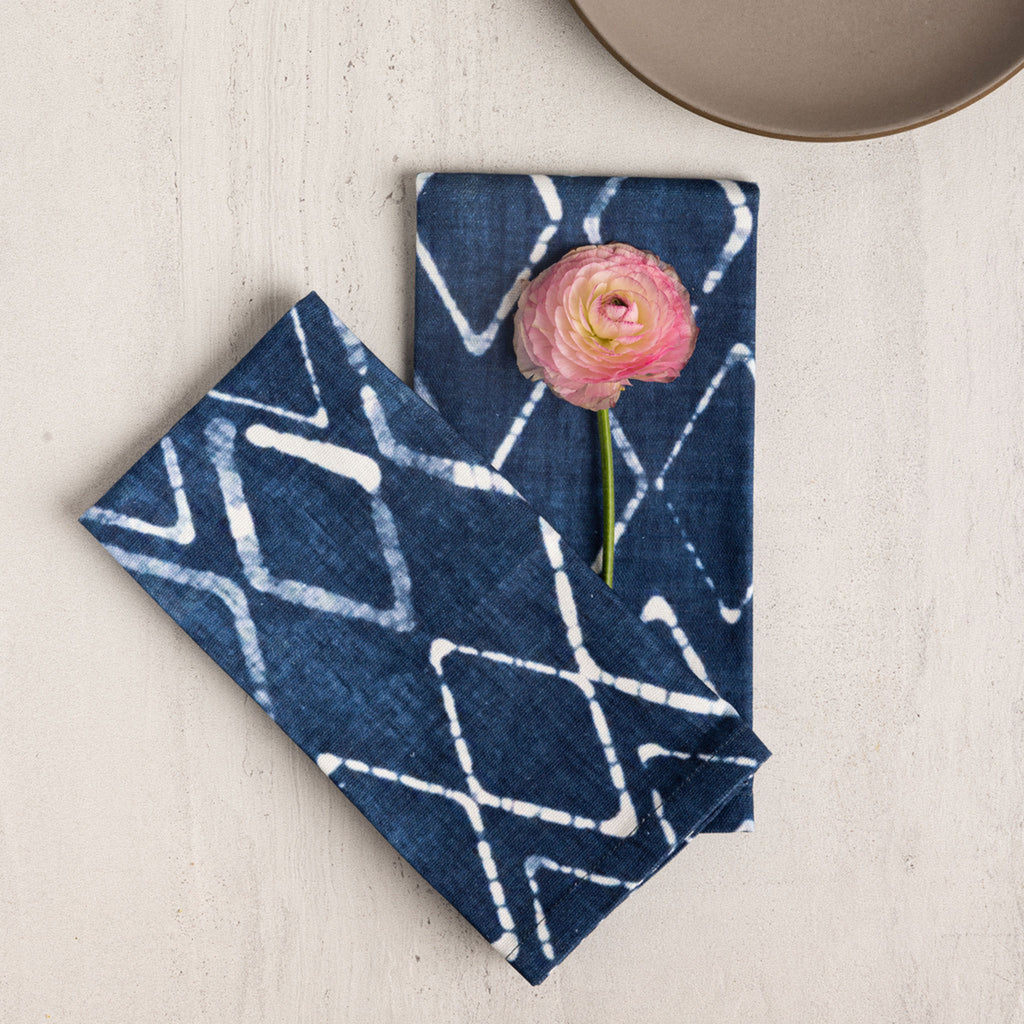 Wolf & Irving organic cotton napkins with a navy blue and white batik pattern and a flower.