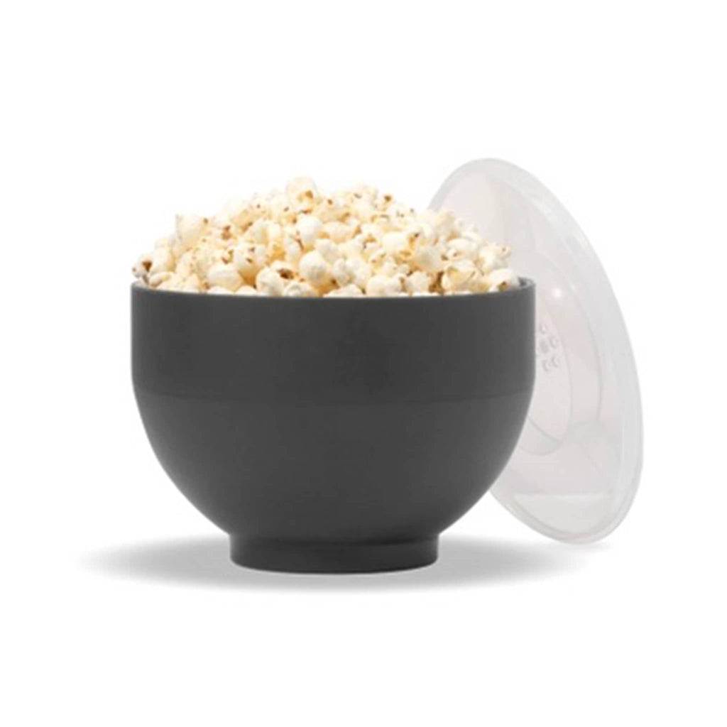 w&P the popper collapsible silicone popcorn making bowl side view with popcorn and lid leaning on the side.