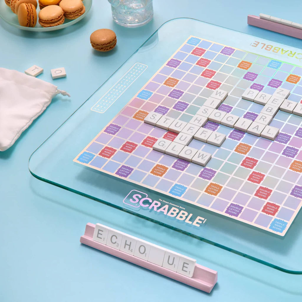 WS Game Company Scrabble classic crossword game, Aura edition, in play on an aqua blue background.