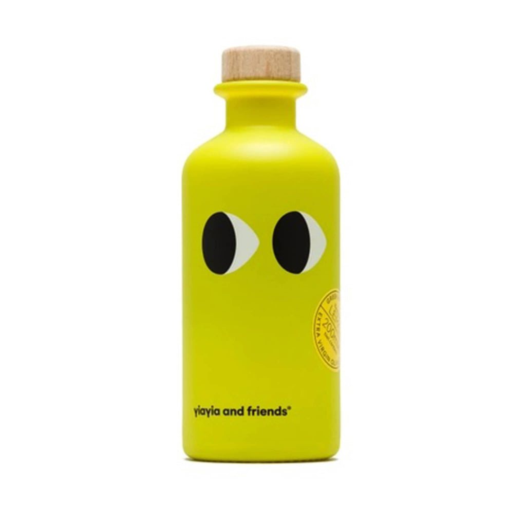 yiayia and friends lemon infused greek extra virgin olive oil in yellow glass bottle with eyes.