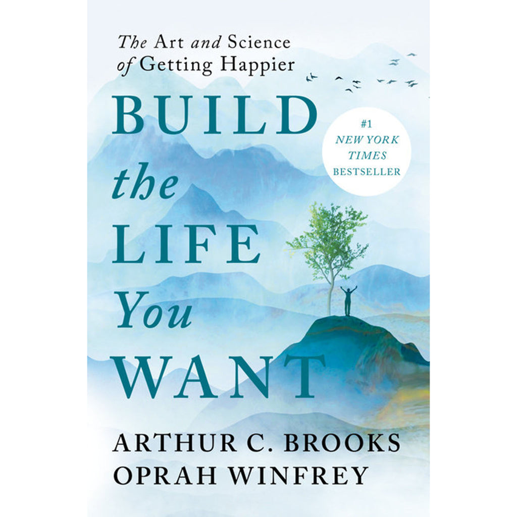 Penguin Random House Build the Life You Want: The Art and Science of Getting Happier, by Arthur C. Brooks and Oprah Winfrey, hardcover book front cover with blue mountain illustration and a person standing on a hill beside a lone tree.