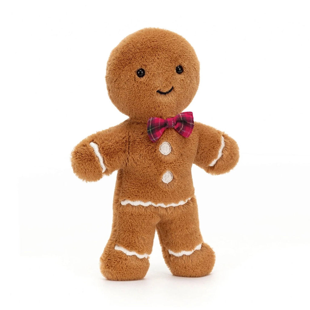 Jellycat Medium Jolly Gingerbread Fred holiday plush toy with tan fur, white stitched "icing" details, black button eyes, stitched smile and a red plaid bow tie, front view.