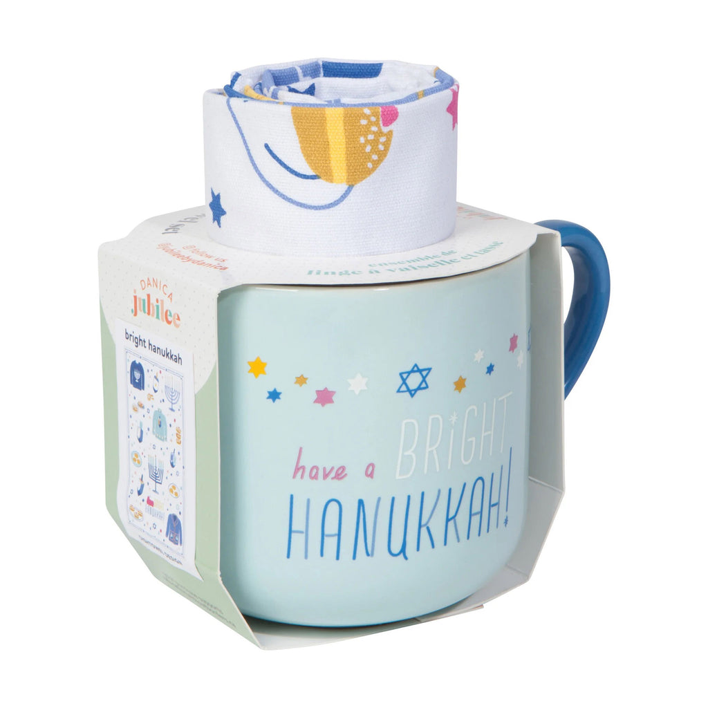 Danica Bright Hanukkah pale blue ceramic mug with dishtowel rolled up inside it, with belly band packaging.