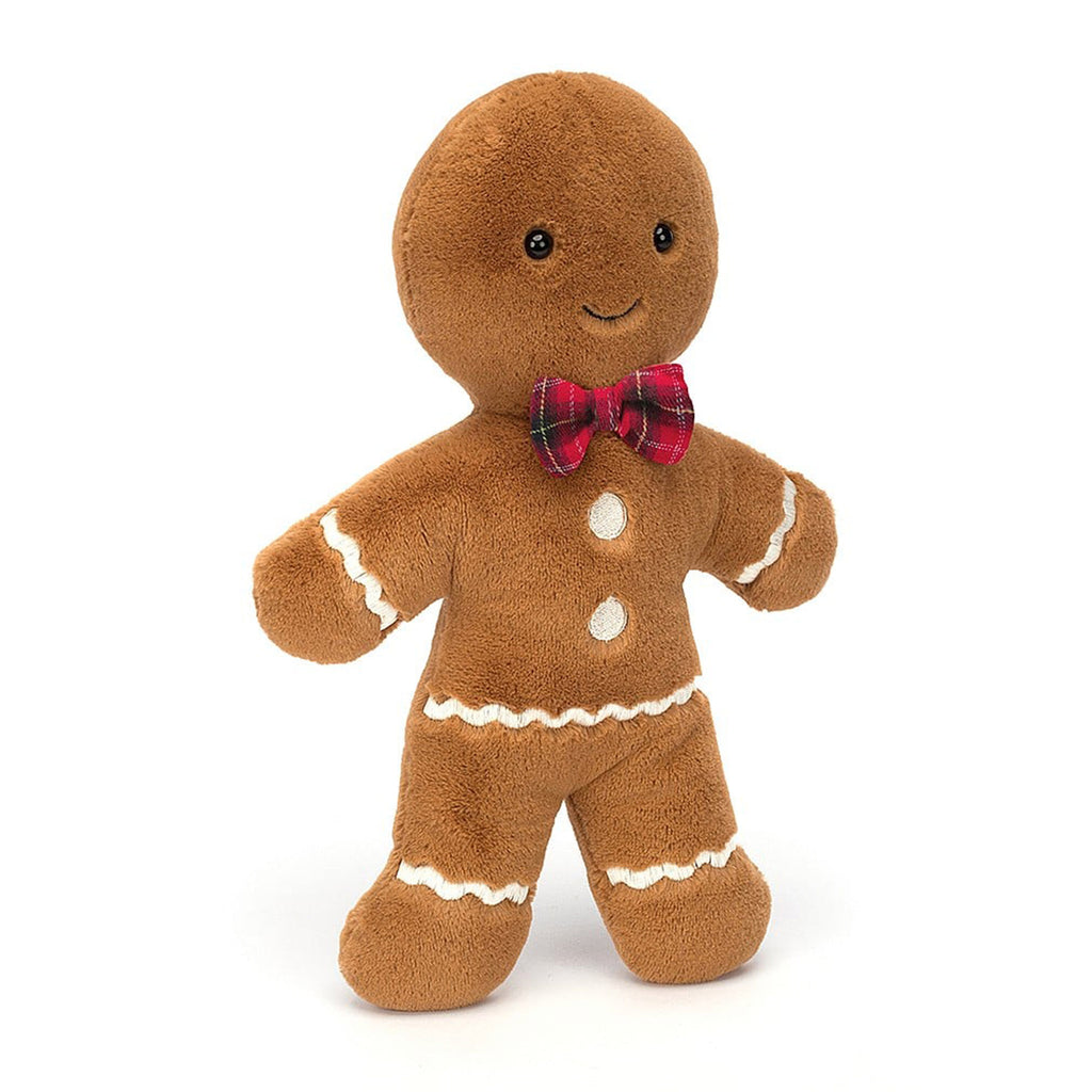 Jellycat Large Jolly Gingerbread Fred holiday plush toy with tan fur, white stitched "icing" details, black button eyes, stitched smile and a red plaid bow tie, front view.