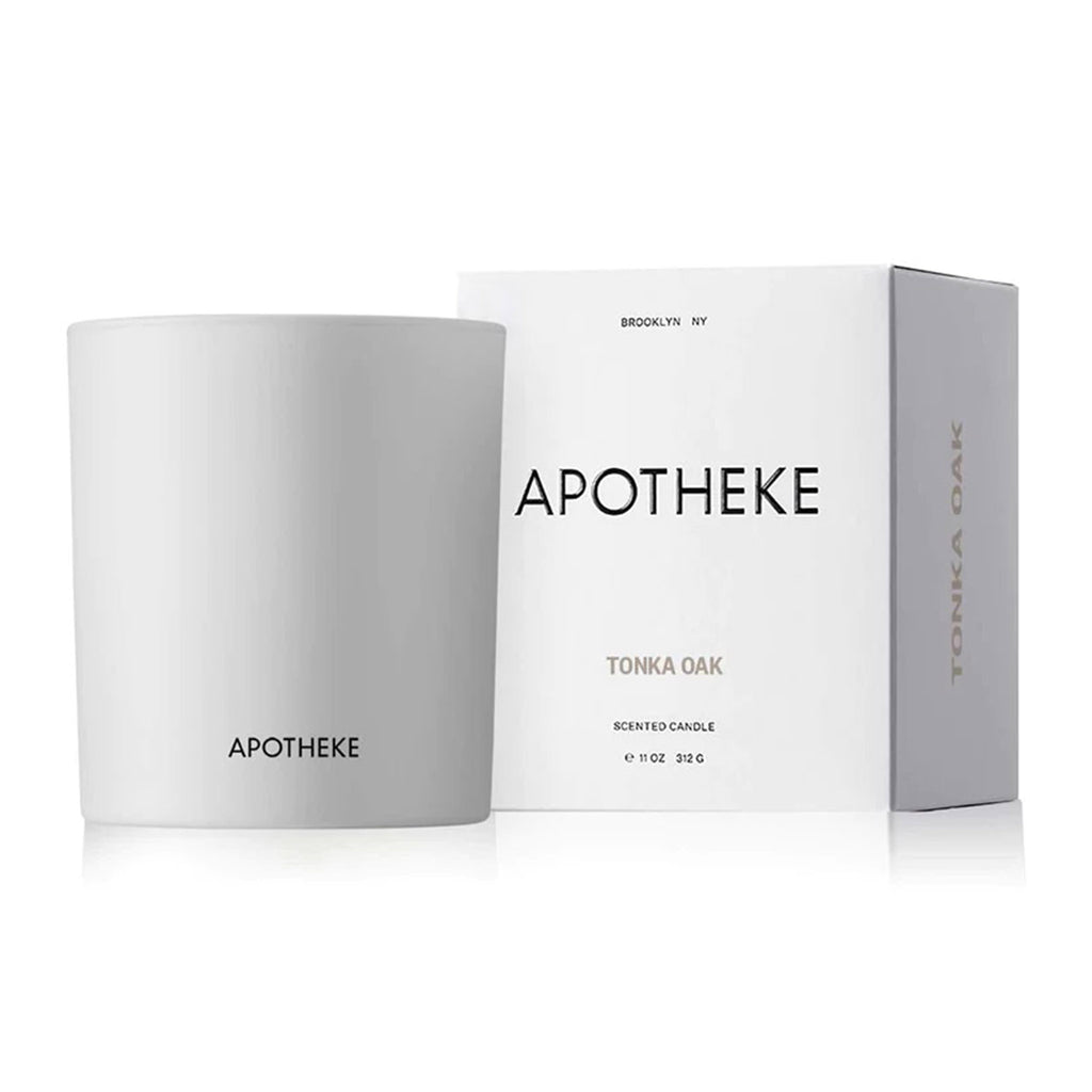 Tonka Oak scented candle from Apotheke in matte white glass vessel with white gift box that has black and gray lettering.