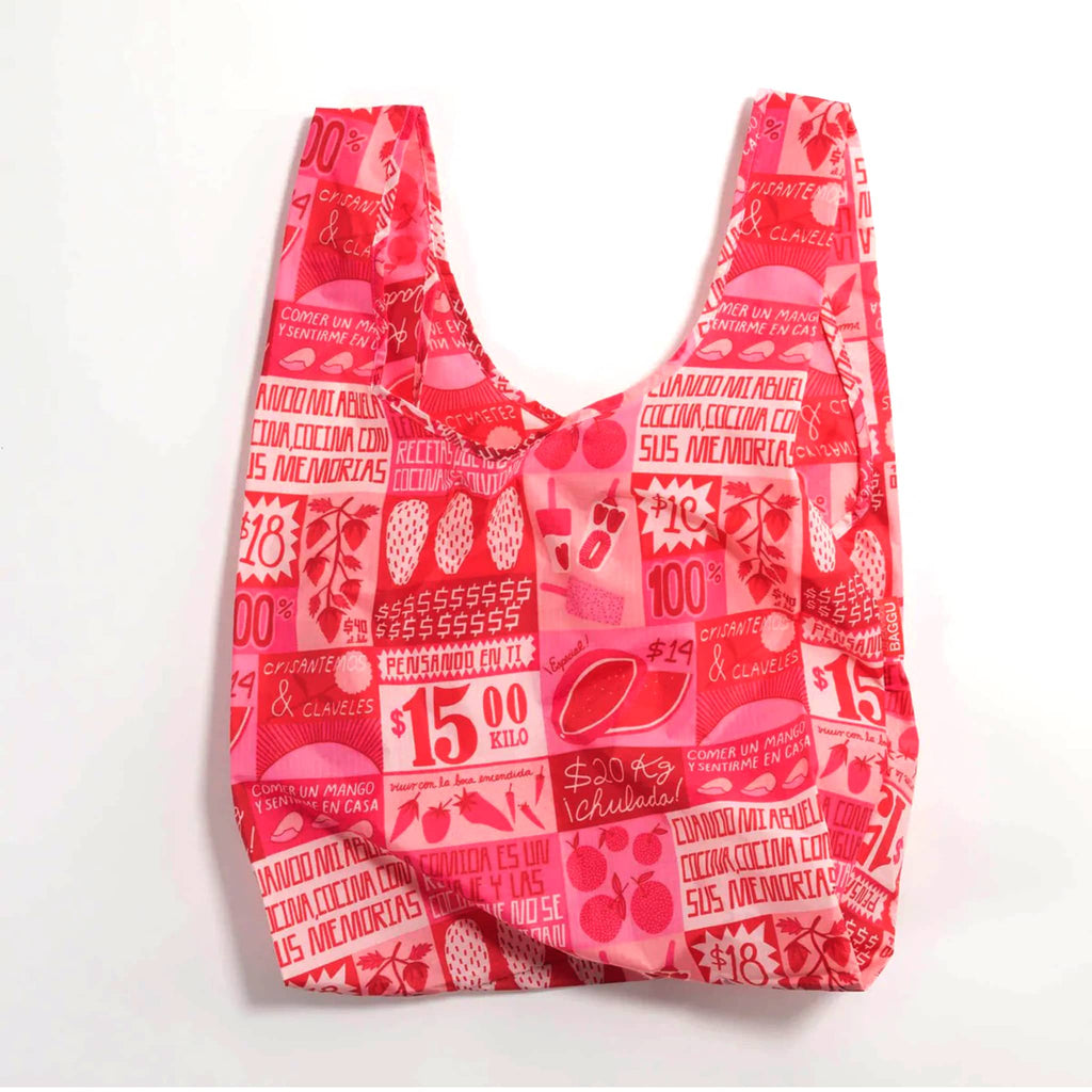 Standard size Baggu reusable ripstop nylon tote bag unfolded with red and pink mercado print.