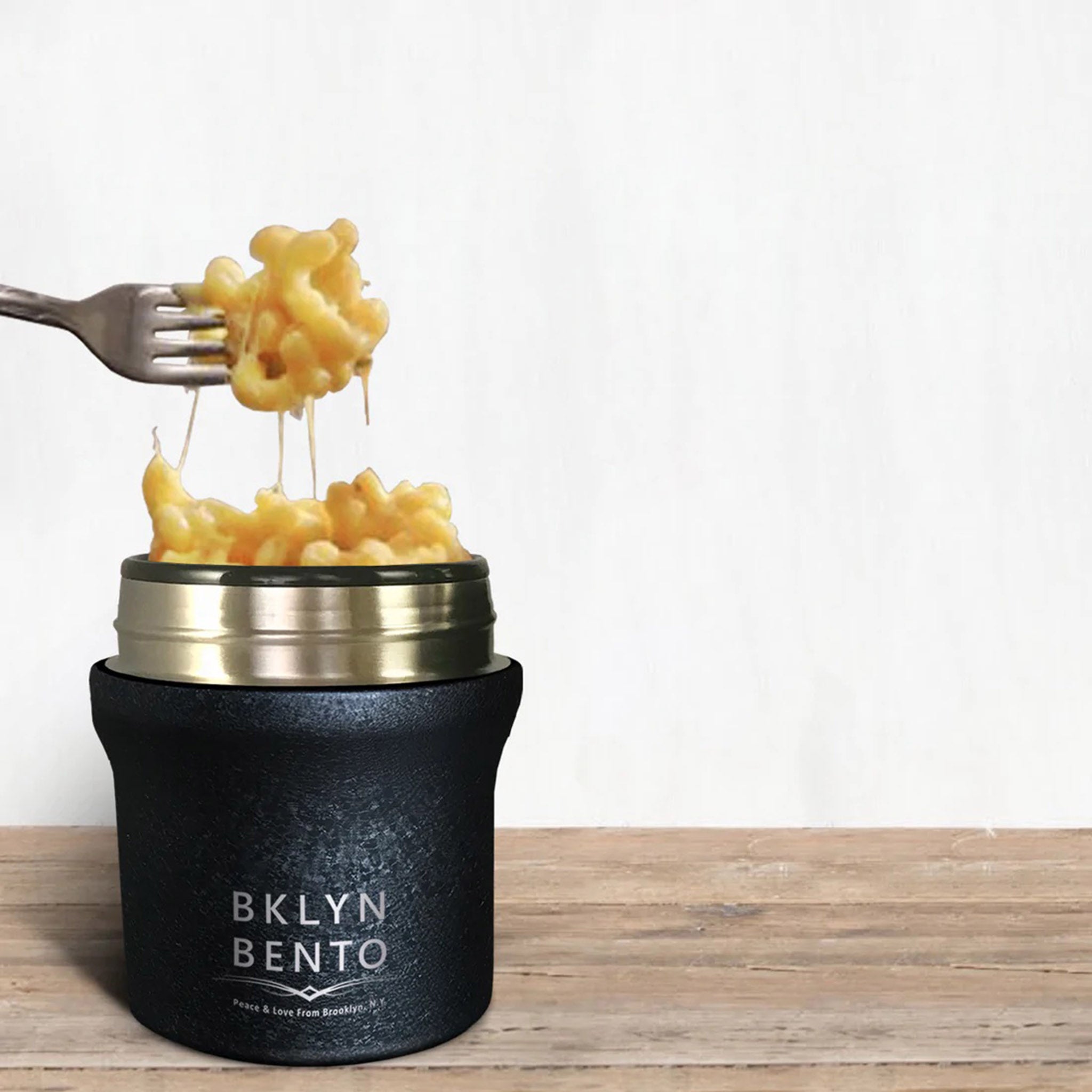 https://blueribbongeneralstore.com/cdn/shop/products/bklyn-bento-small-10oz-insulated-food-jar-in-cracked-coal-black-with-lid-off-with-mac-and-cheese.jpg?v=1659540194