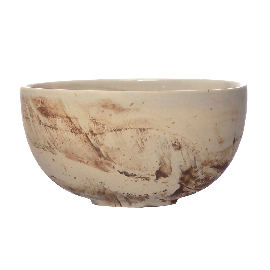 Bloomingville sand colored stoneware bowl with brown reactive glaze in swirl patterns.