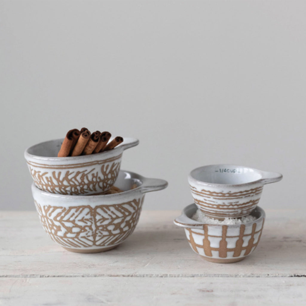 creative co-op set of four nesting stoneware measuring cups with wax relief pattern in use