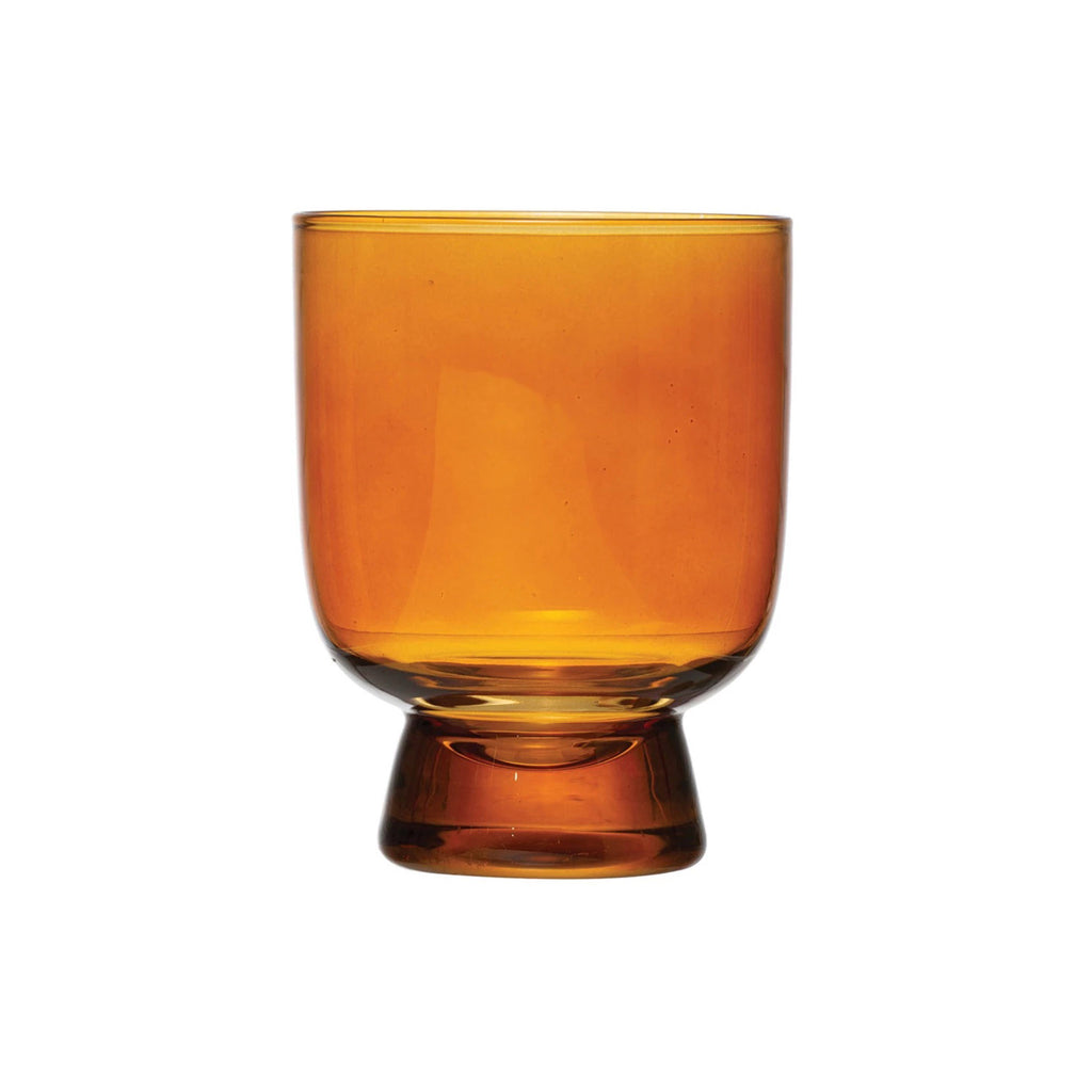 Creative Co-op Amber 6 ounce round footed drinking glass.