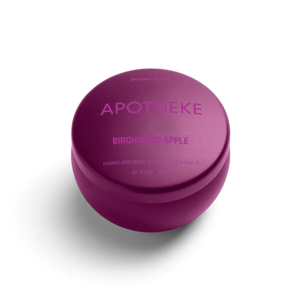 Apotheke Birchwood Apple limited edition winter scented soy wax candle in plum colored mini tin with lid.