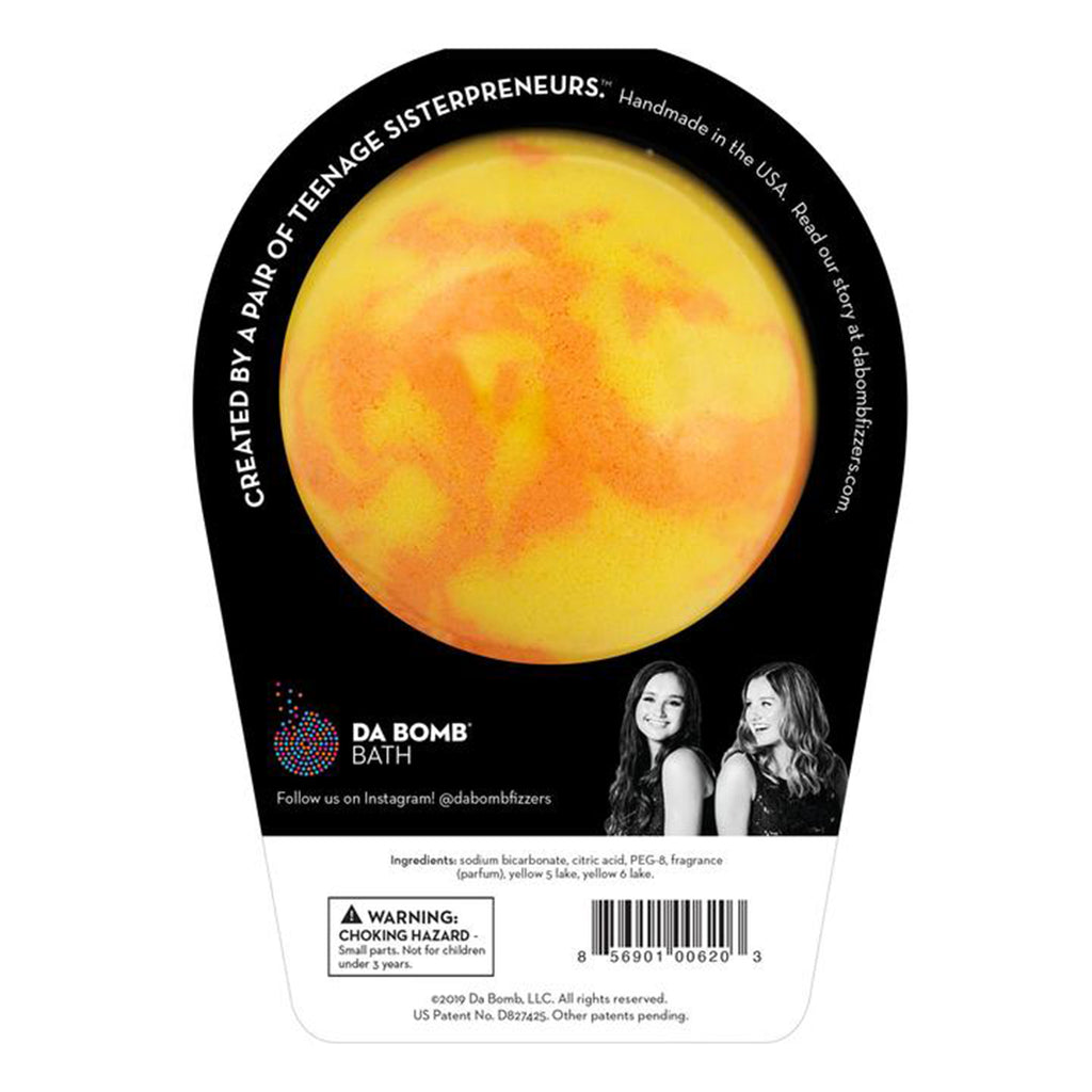 da bomb beach bomb yellow orange ball bath fizzer with island mango scent and surprise inside in black packaging with white lettering back