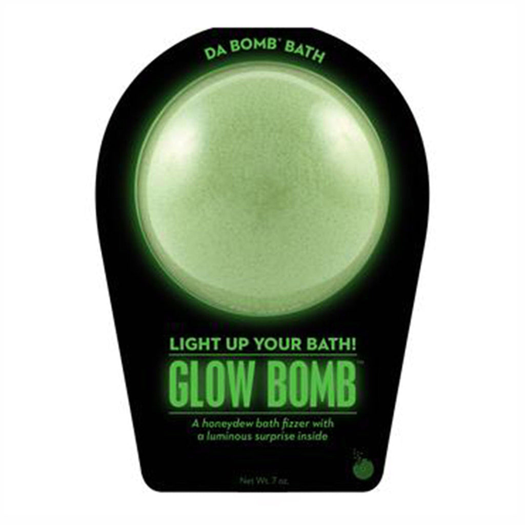 Da Bomb Glow Bomb, glow-in-the-dark green bath fizzer with honeydew scent and a light-up surprise inside, in black clamshell packaging, front view.