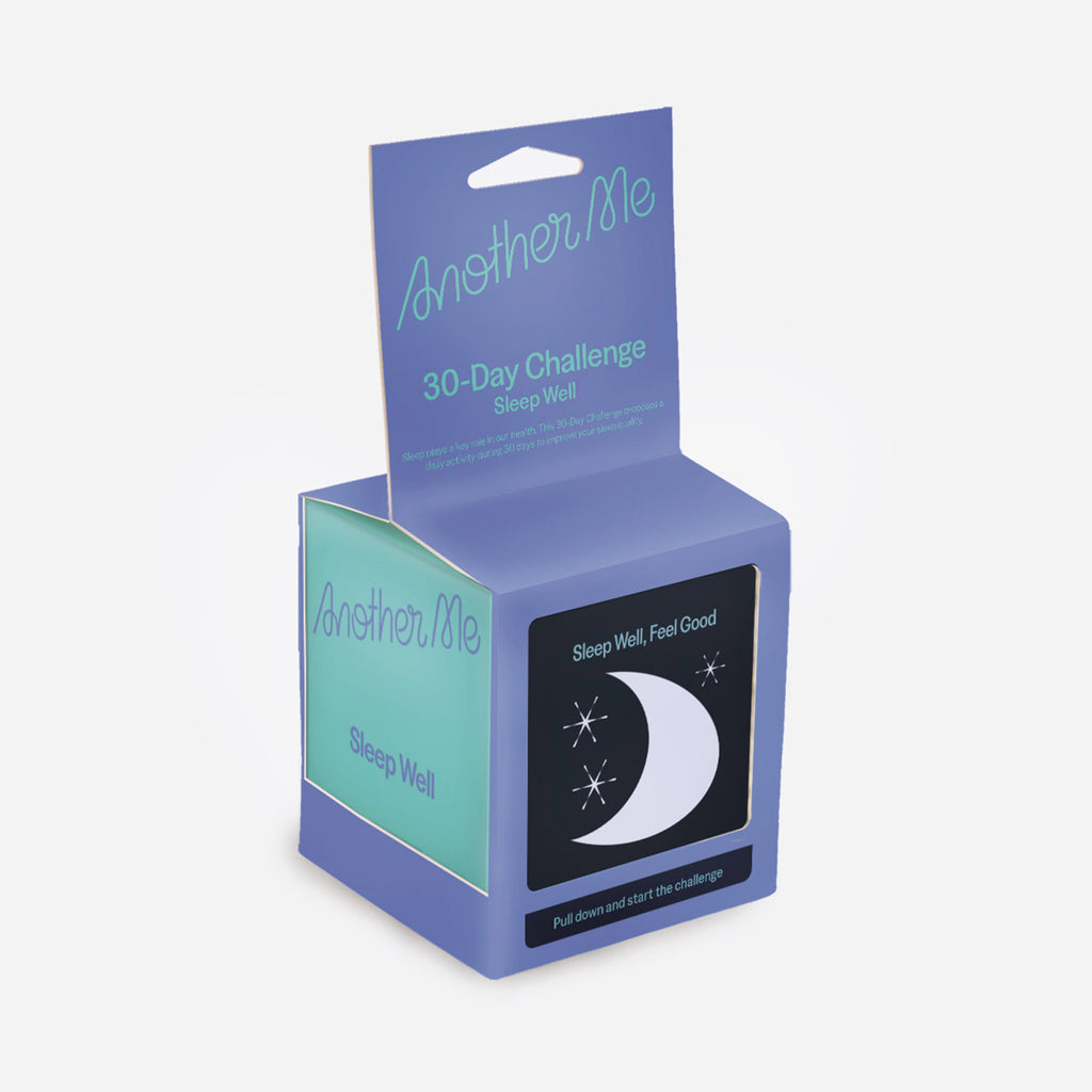 30 day sleep well challenge box with daily activity tickets inside. Box is aqua with a blue sleeve and hangtag surrounding it. Front says "sleep well, feel good, pull down and start the challenge" with a half moon graphic.