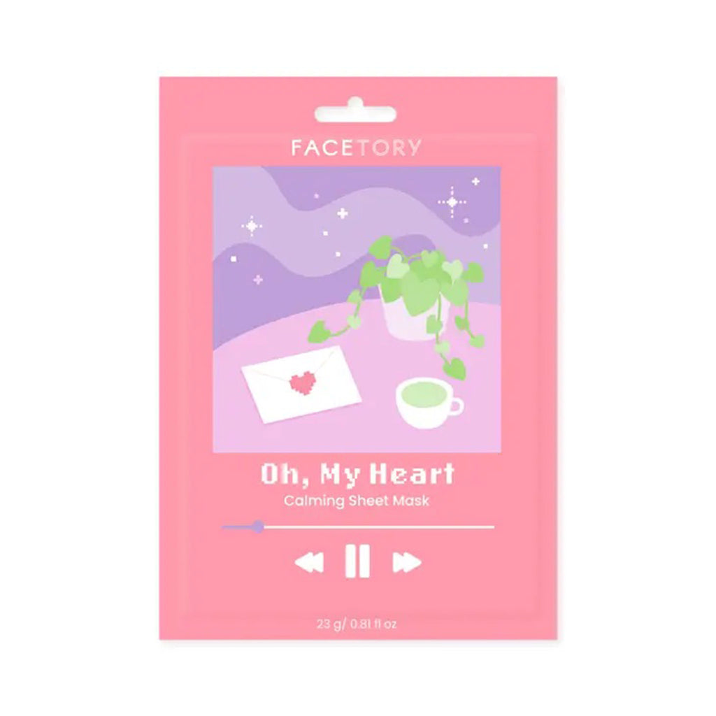 Facetory Oh, My Heart Calming Sheet Mask in pink packet packaging with illustration of a plant and a cup of green tea on a pink table with a letter sealed with a heart on it.