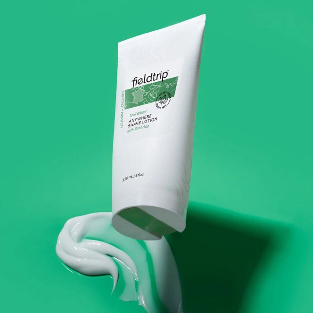 Fieldtrip Trail Blazer Anywhere Shave Lotion with Birch Sap in green and white tube with product smear on green background.