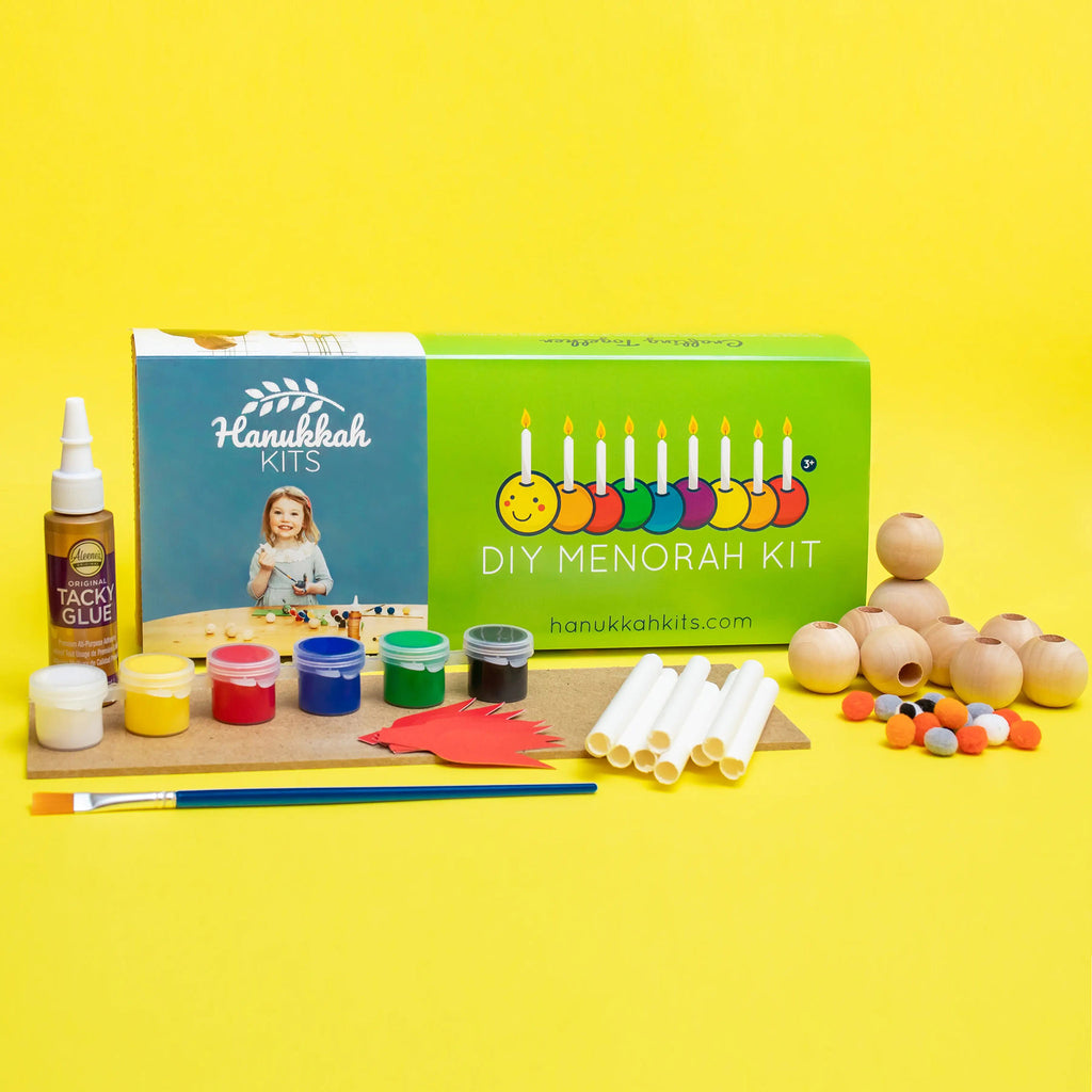DIY caterpillar menorah kit for kids, box packaging with contents in front on a yellow background.