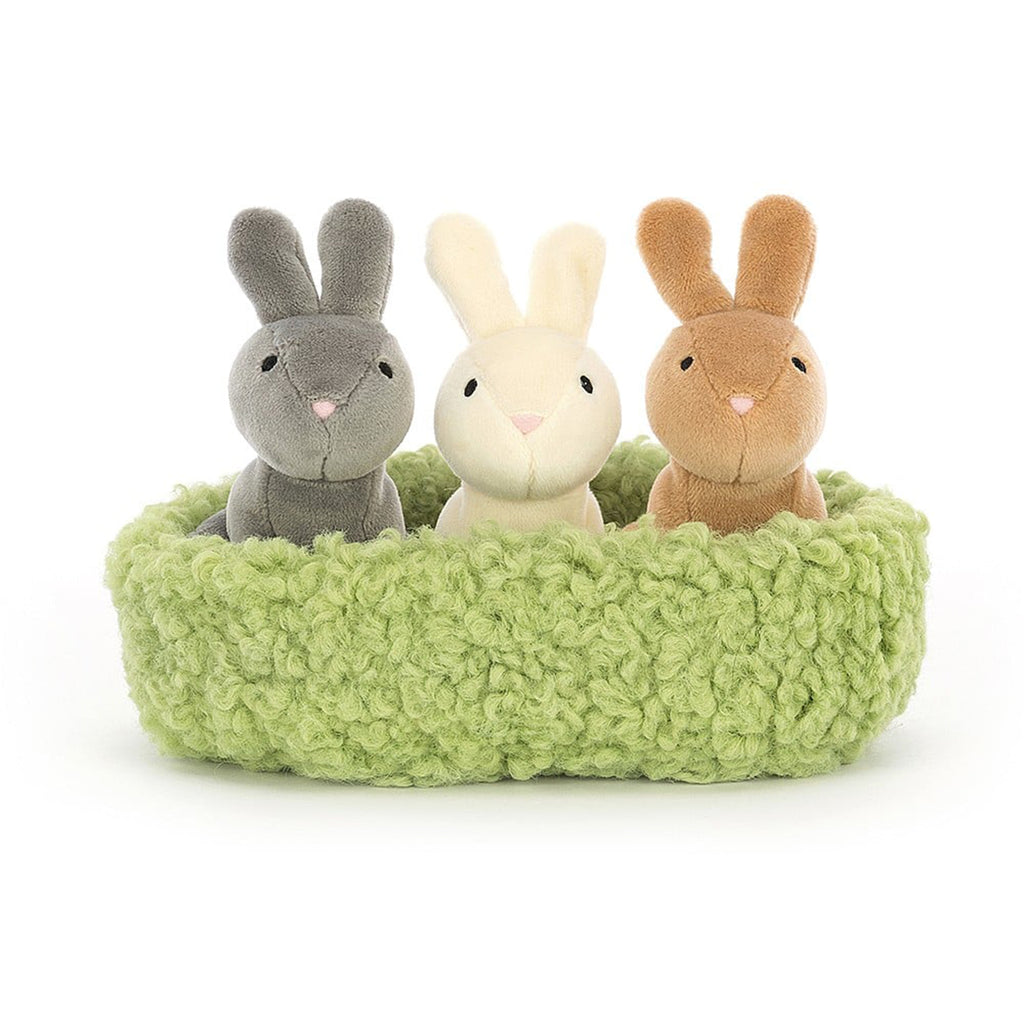 Jellycat Nesting Bunnies Plush Toy with a gray, cream and tan bunny sitting in a plush light green nest, front view.