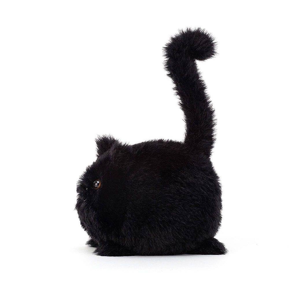 Ball shaped black kitten caboodle stuffie plush toy side view with brown eyes, pink nose, white mouth and a tail sticking straight up with a little curl at the end.