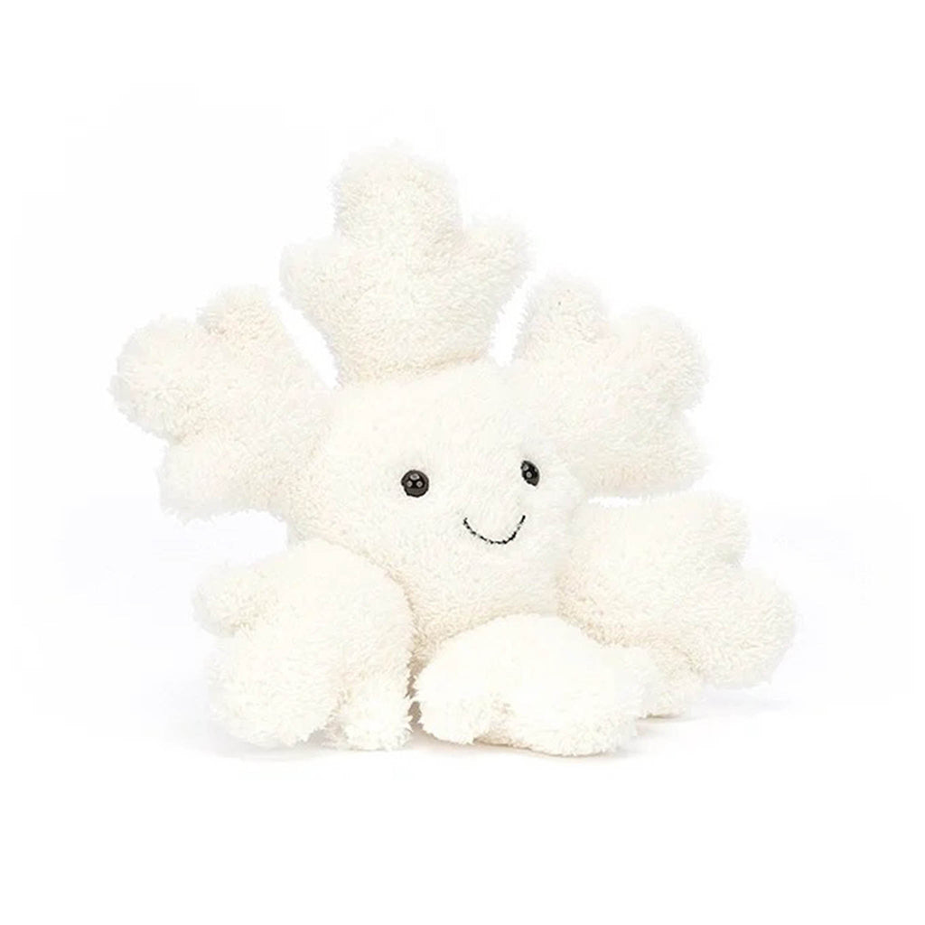 White snowflake shaped plush toy with black bead eyes and stitched smile, front view.