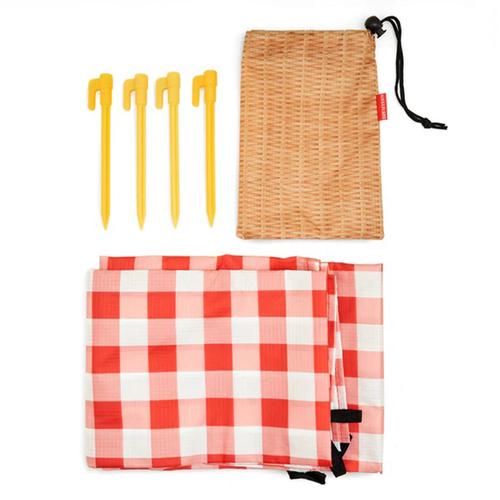 Kikkerland red & white gingham print ripstop nylon picnic blanket with wicker print pouch and 4 yellow stakes.
