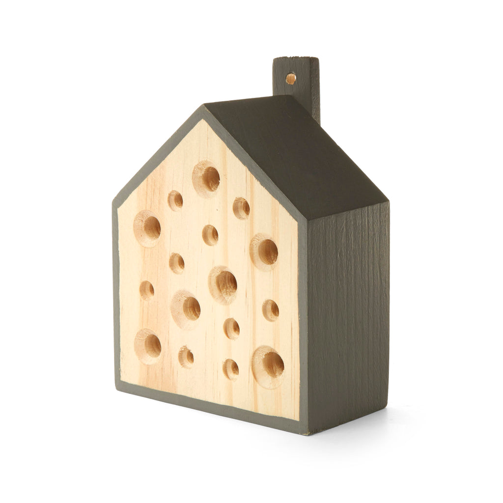Kikkerland wooden Little Bee House with holes drilled in assorted sizes on the front.