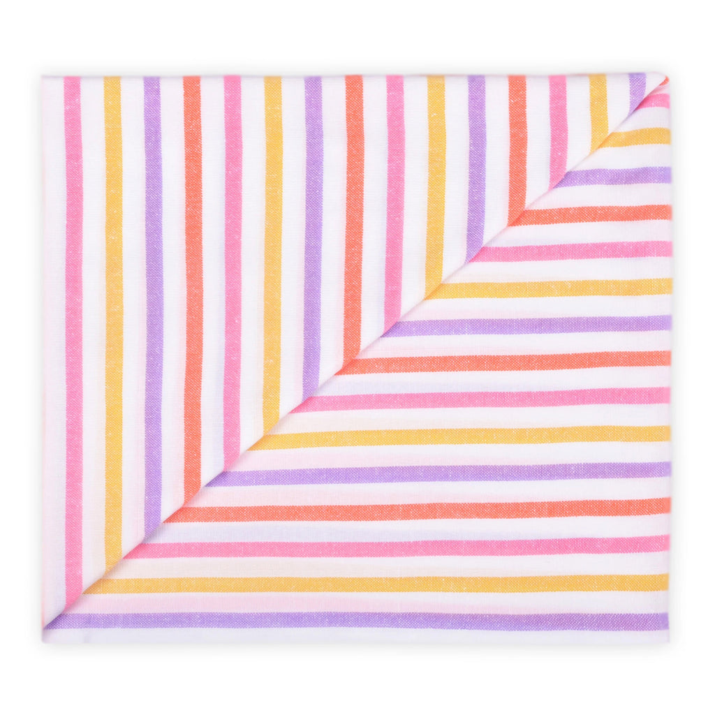 Las Bayadas La Gaby pink, orange, purple and yellow striped woven cotton blend beach blanket towel, folded.
