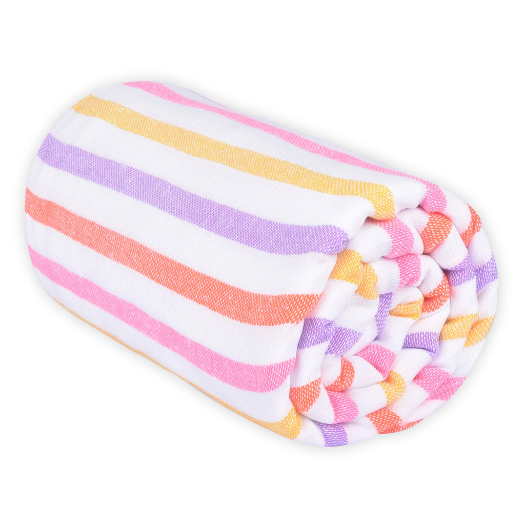 Las Bayadas La Gaby pink, orange, purple and yellow striped woven cotton blend beach blanket towel, rolled up.