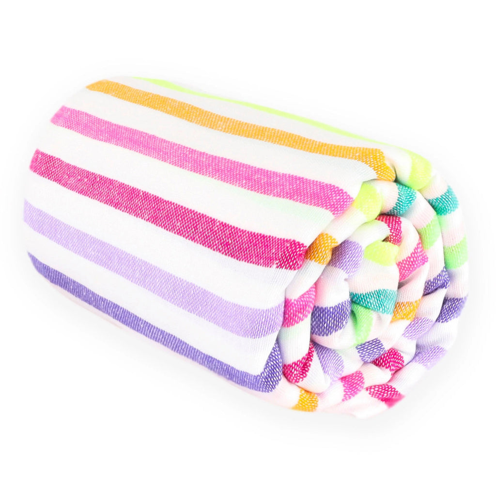Las Bayadas La Renata colorful striped woven cotton blend beach blanket towel, rolled up.