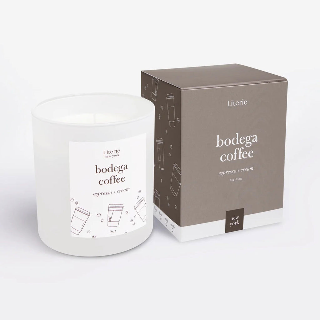 "Bodega Coffee" espresso and cream scented candle by Literie in a white matte glass tumbler with name of candle and coffee beans and cup illustrations in brown and matching brown gift box with coffee beans and cup illustrations in white on the side.