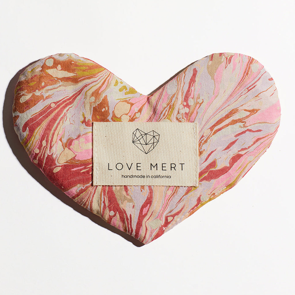 love mert heart shaped love eye pillow in peony color scheme with orange, pink and red swirls