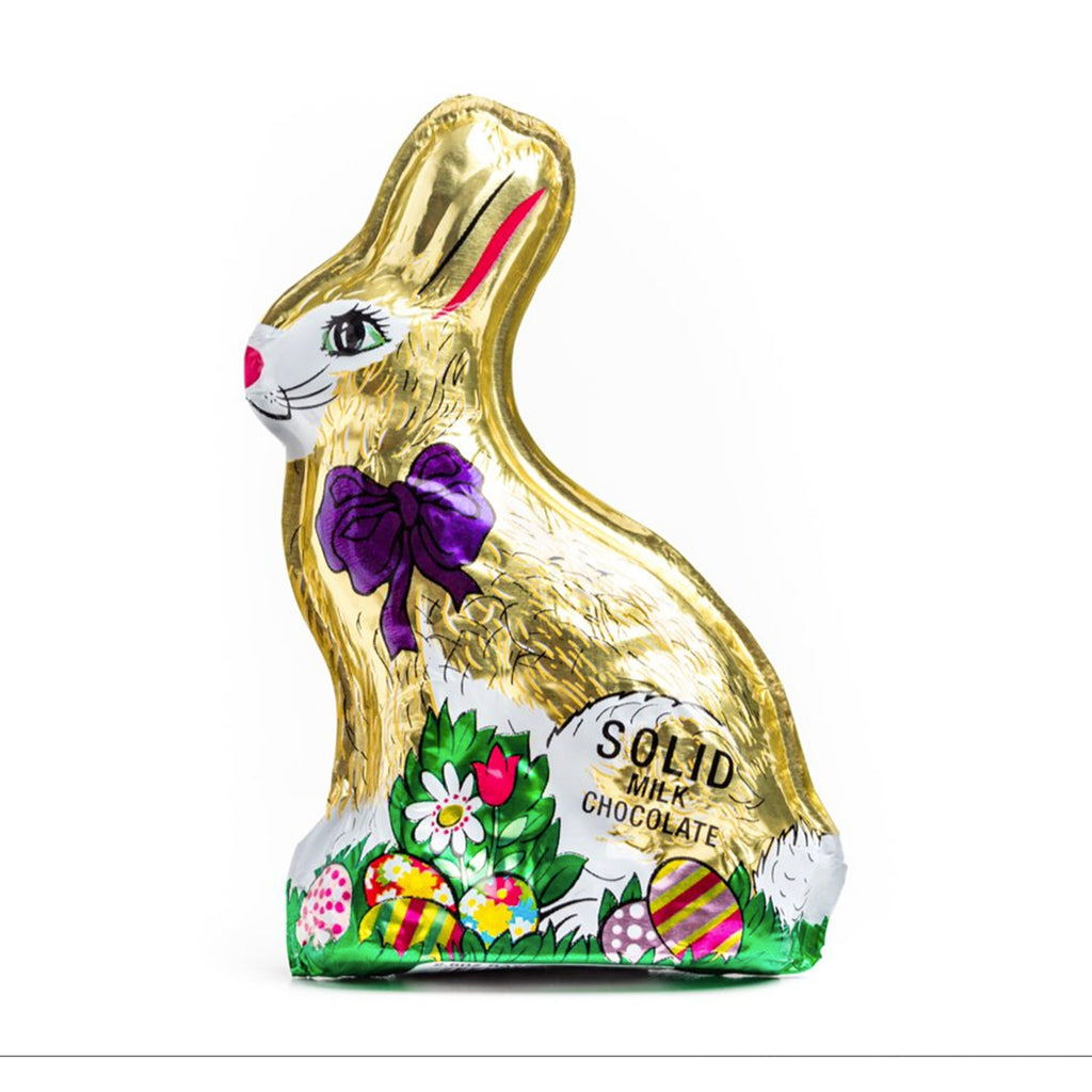 nassau candy madelaine 2.5 ounce decorative foil wrapped sitting rabbit solid milk chocolate easter bunny with a purple bow and colored easter eggs at its feet