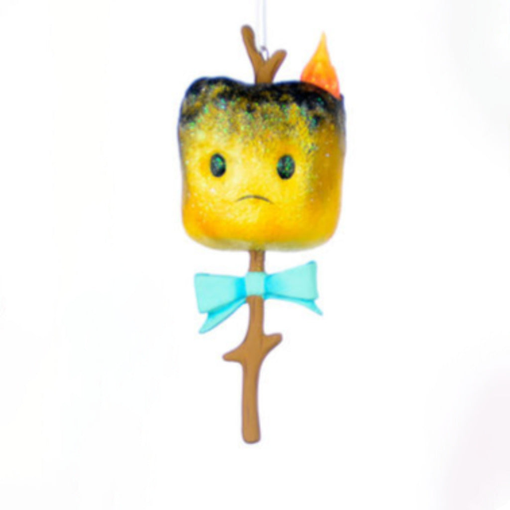 burnt marshmallow on branch with a frowning face wearing a blue bow tie