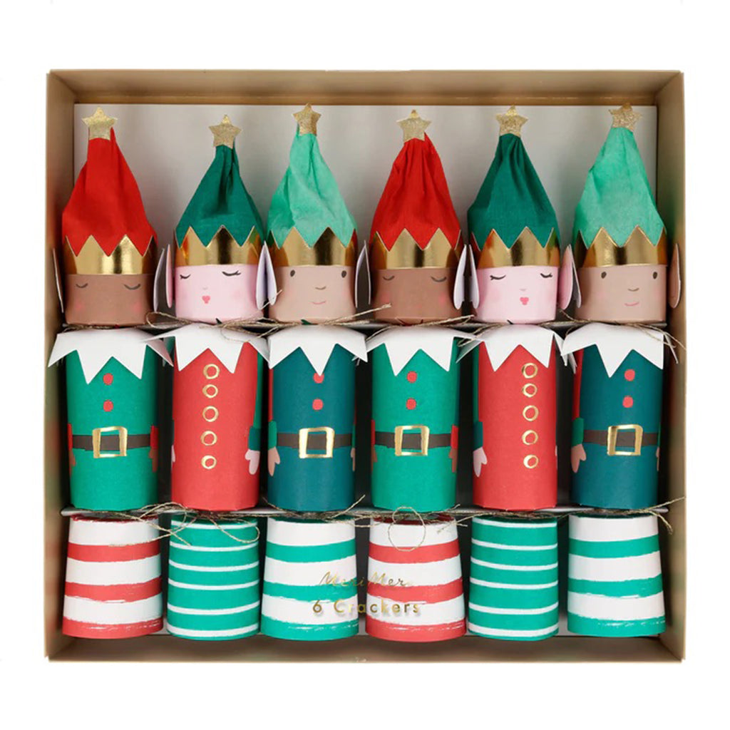 Elf party crackers dressed in red, green, white and gold outfits with striped bottoms and gold glitter stars on the top of their hats, in paper packaging.