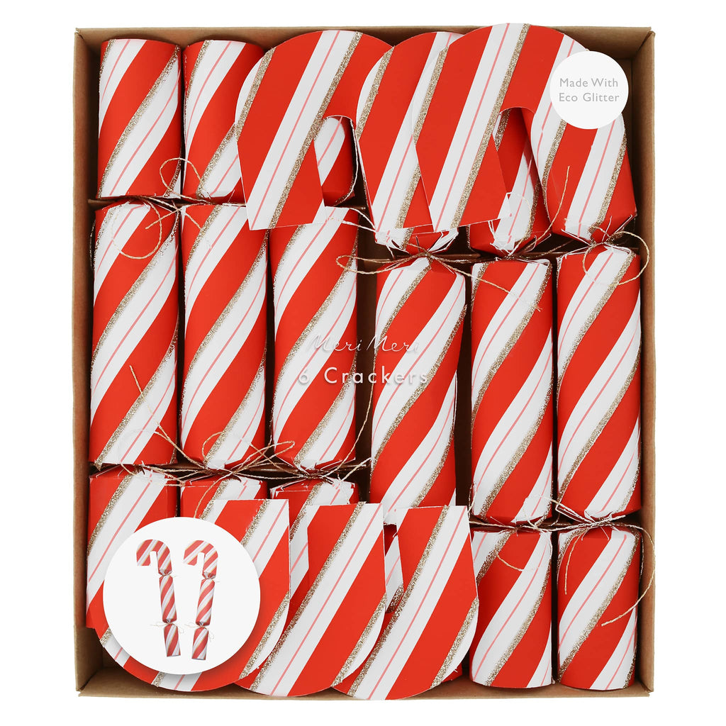 Candy cane holiday party crackers with red and white stripes and gold glitter details in paper packaging.