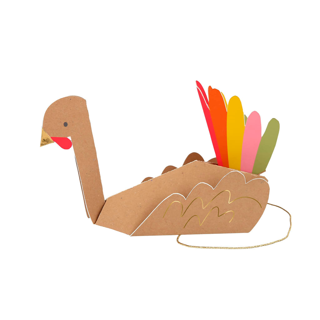 Folded paper party hat that looks like a turkey with gold foil beak and colorful tail feathers with a gold elastic headband.