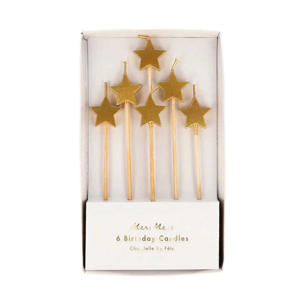 Set of 6 star shaped gold wax candle tips on wooden sticks in 3 different lengths, in paper packaging.