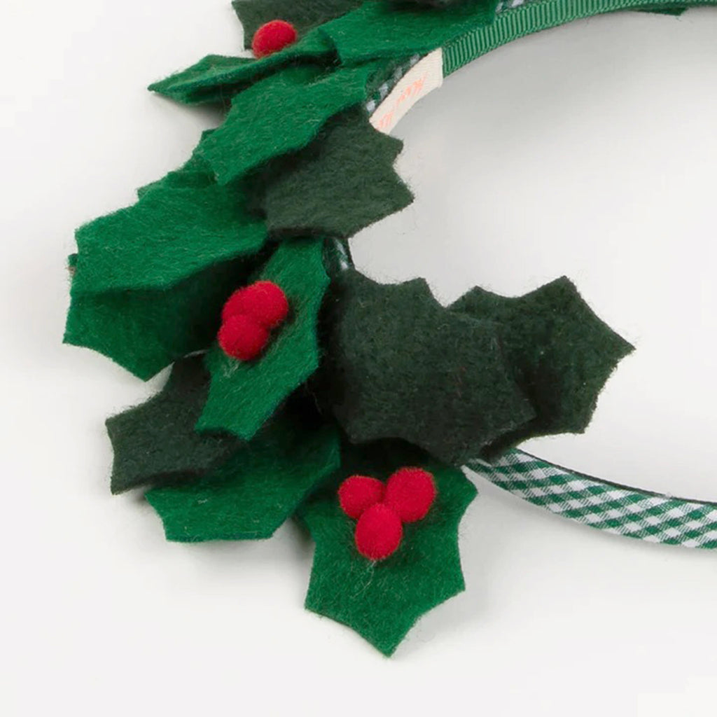 Green gingham ribbon headband with green felt holly leaves and red pompom holly berries attached, detail. 