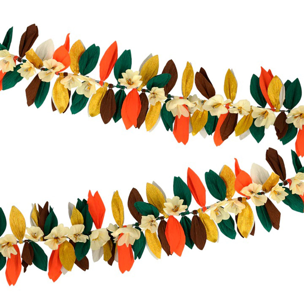 Crepe paper leaf and flower garland in fall colors of green, brown, orange and gold strung on a green gingham ribbon, detail.