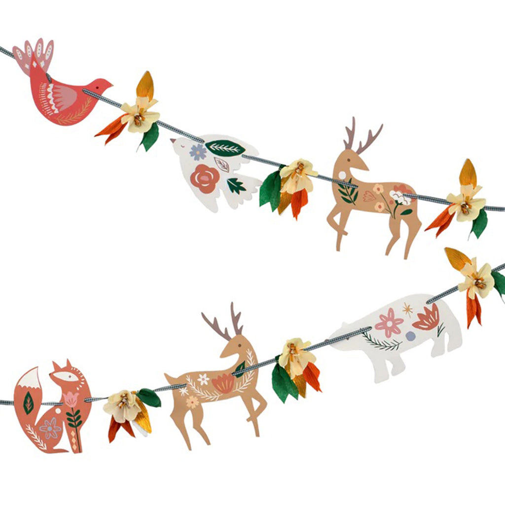 Detail of woodland animals with folk art type illustrations and crepe paper flower and leaf clusters strung on a green gingham ribbon. 